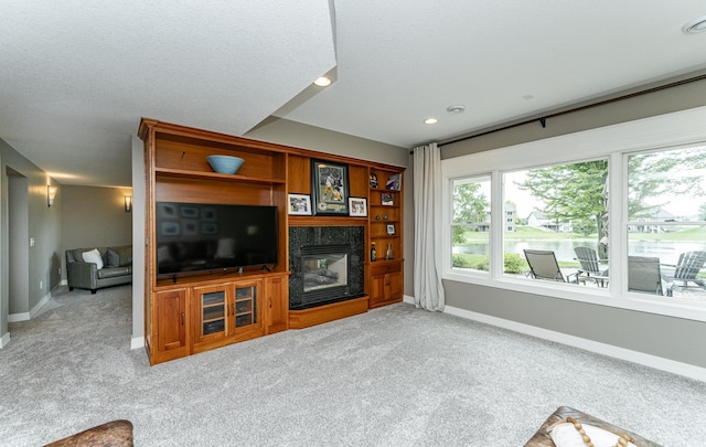 3942 Autumn Lake Ct SW, Rochester, MN 55902 - living area with light carpet, healthy amount of natural light, a fireplace, and recessed lighting
