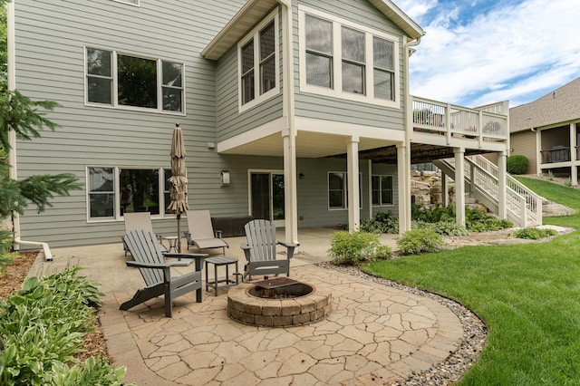 3942 Autumn Lake Ct SW, Rochester, MN 55902 - back of property with a fire pit, a patio area, a wooden deck, a lawn, and stairs