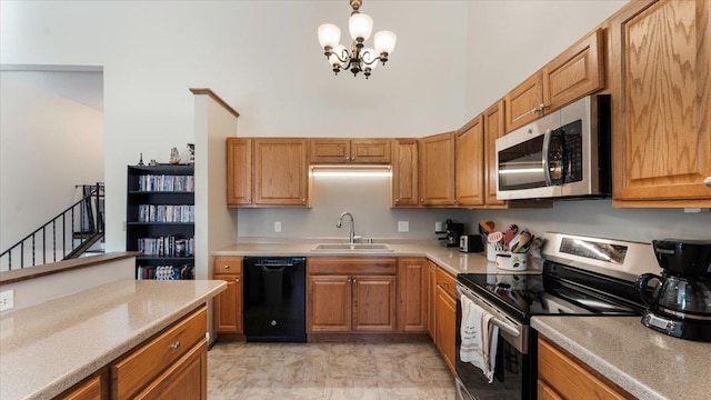 kitchen featuring brown cabinets, appliances with stainless steel finishes, light countertops, and a sink