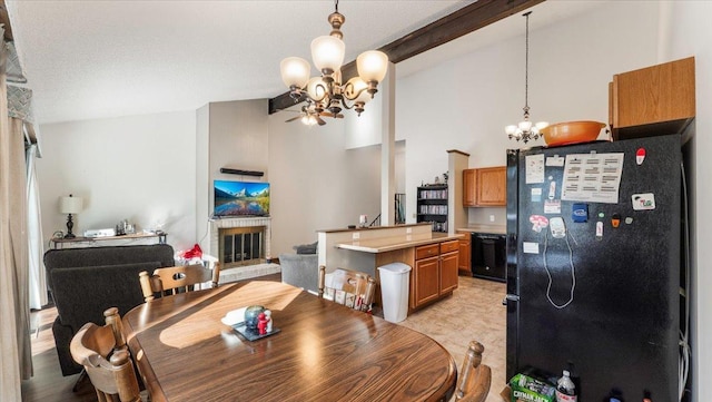 dining room featuring beam ceiling, a notable chandelier, a brick fireplace, and high vaulted ceiling