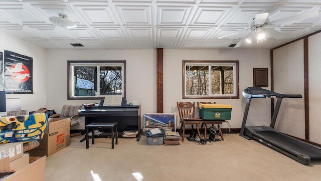 interior space featuring visible vents, an ornate ceiling, a ceiling fan, and carpet flooring