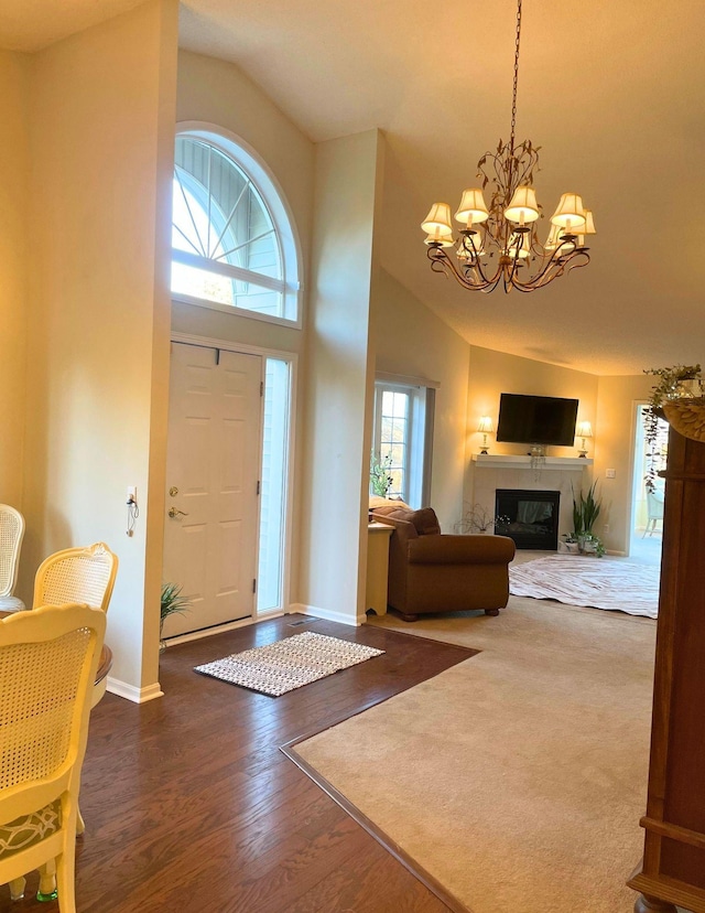 entrance foyer featuring dark hardwood / wood-style floors, a chandelier, and high vaulted ceiling