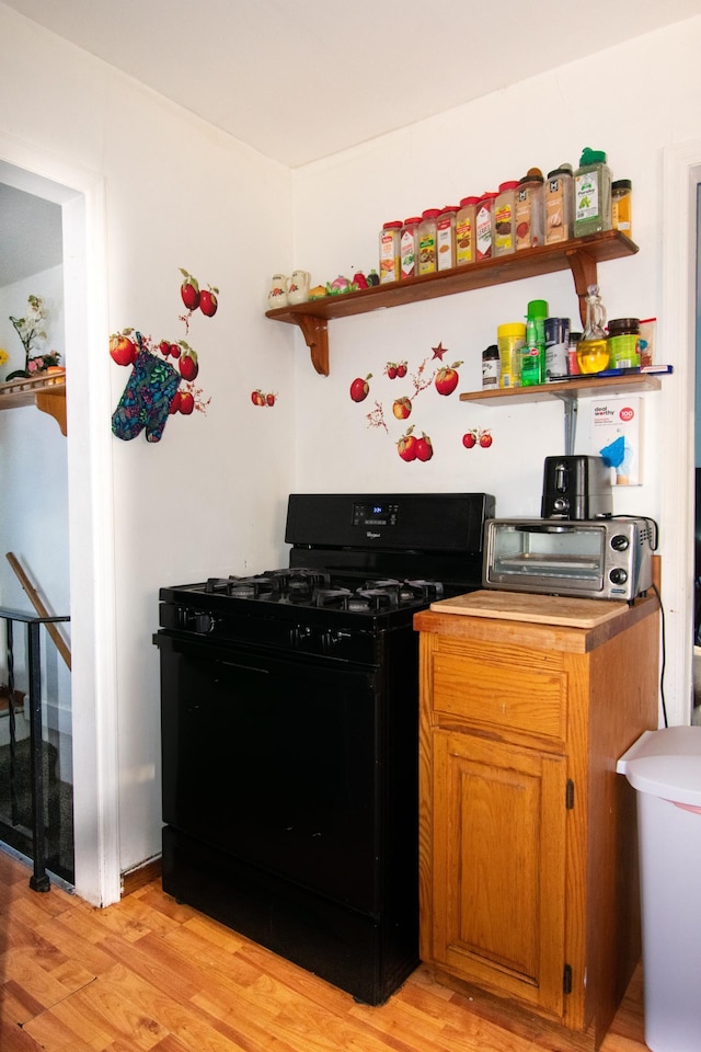 kitchen featuring light hardwood / wood-style floors and gas stove