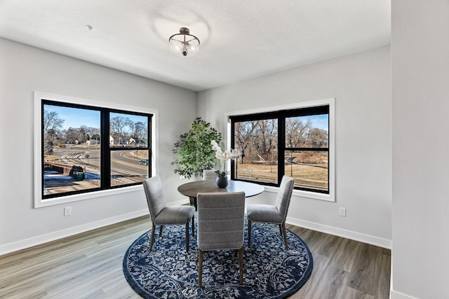 dining space featuring hardwood / wood-style floors and a textured ceiling