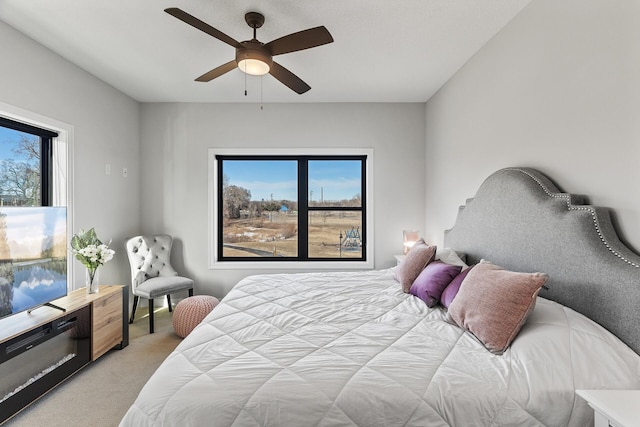 bedroom featuring light carpet and ceiling fan