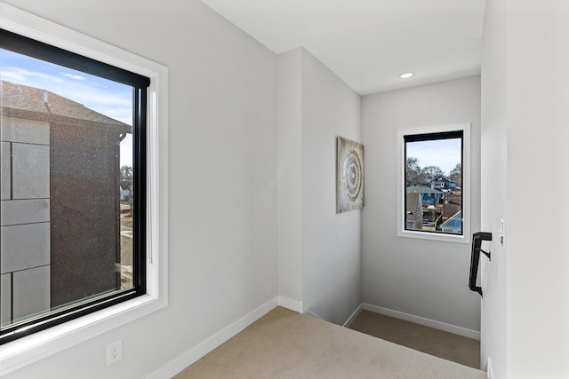 carpeted empty room featuring a wealth of natural light