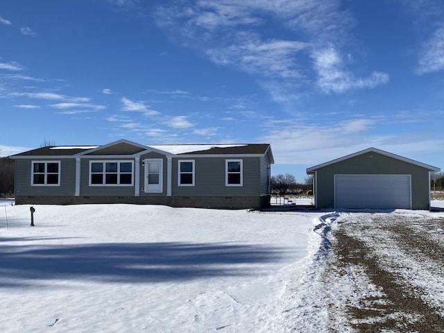 view of front of home with a garage and an outdoor structure