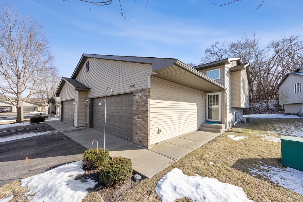 view of snowy exterior with a garage