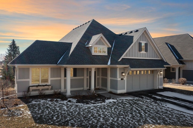 view of front facade featuring covered porch, aphalt driveway, board and batten siding, and roof with shingles