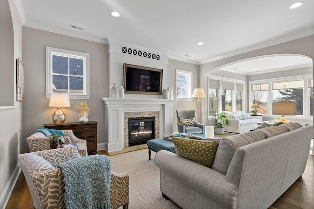 living area with recessed lighting, wood finished floors, and a high end fireplace