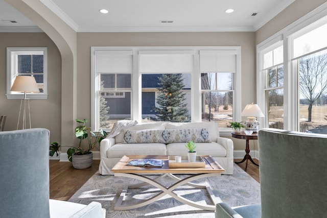 sunroom featuring arched walkways and visible vents