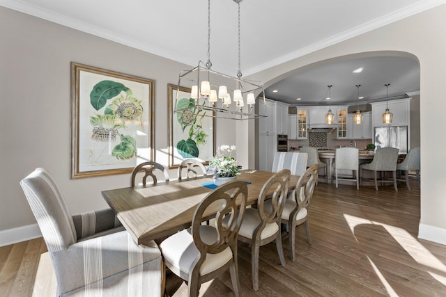 dining room with dark wood-style floors and ornamental molding