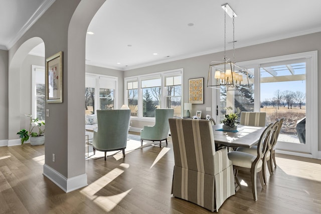 dining area featuring arched walkways, ornamental molding, and dark wood-style flooring