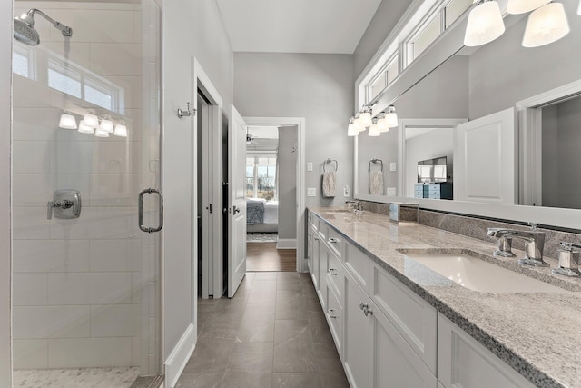 ensuite bathroom featuring double vanity, a stall shower, a sink, and ensuite bath