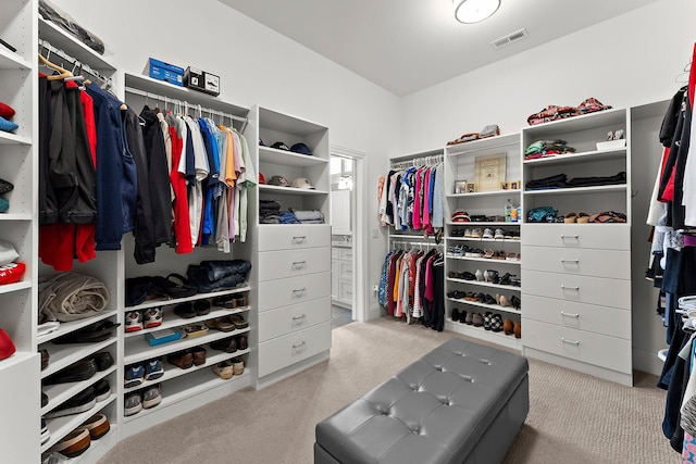 walk in closet with visible vents and carpet flooring