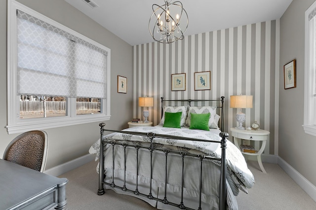 carpeted bedroom featuring visible vents, a notable chandelier, baseboards, and wallpapered walls