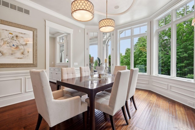 dining space featuring hardwood / wood-style flooring and ornamental molding