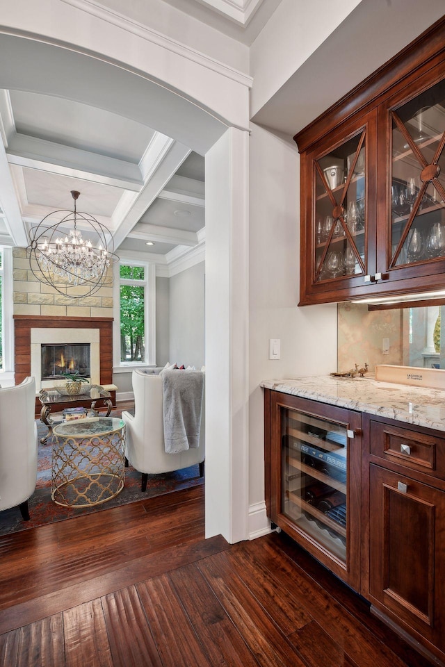 bar featuring beam ceiling, dark hardwood / wood-style floors, coffered ceiling, light stone counters, and wine cooler