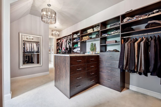 walk in closet featuring light carpet, a notable chandelier, and lofted ceiling