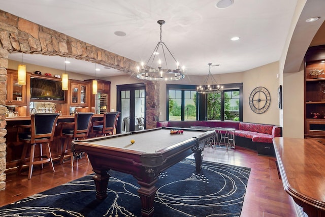 playroom featuring dark hardwood / wood-style floors, bar, pool table, and french doors