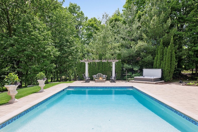 view of swimming pool featuring a patio, a pergola, and a fire pit