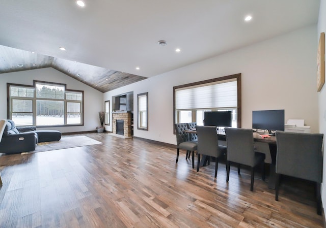 office area with lofted ceiling, a fireplace, and hardwood / wood-style floors