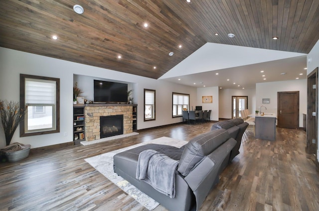 living room with dark hardwood / wood-style floors, high vaulted ceiling, a fireplace, sink, and wooden ceiling