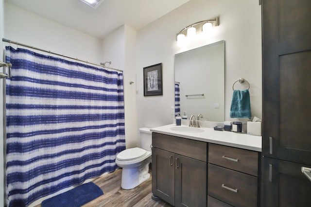 bathroom with walk in shower, vanity, toilet, and hardwood / wood-style floors