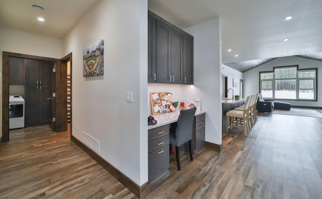 corridor with lofted ceiling, washer / clothes dryer, and dark hardwood / wood-style flooring