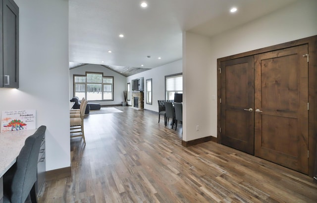 foyer with lofted ceiling and dark hardwood / wood-style floors