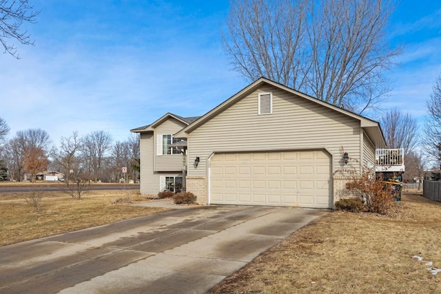 view of side of home featuring a garage, concrete driveway, and brick siding