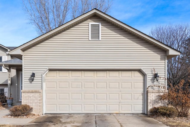 garage featuring concrete driveway