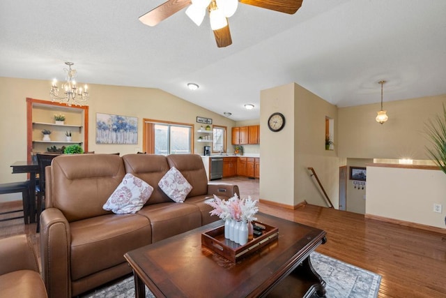 living area with light wood-style floors, vaulted ceiling, baseboards, and an inviting chandelier