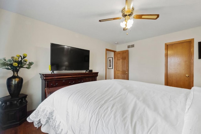 bedroom with a ceiling fan, dark wood-style flooring, and visible vents