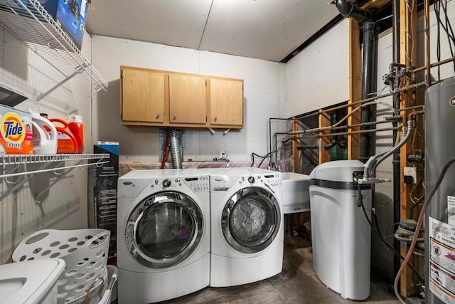 laundry room with washer and dryer, cabinet space, and water heater