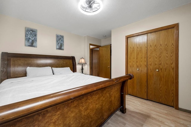 bedroom featuring light wood finished floors and a closet