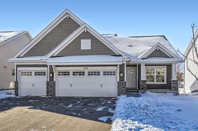 craftsman inspired home featuring a garage, stone siding, aphalt driveway, and entry steps