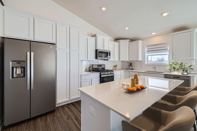 kitchen with appliances with stainless steel finishes, white cabinets, and light countertops