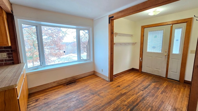 entrance foyer with dark hardwood / wood-style floors