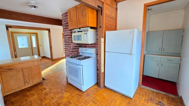 kitchen with white appliances and light parquet floors