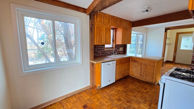 kitchen featuring sink, kitchen peninsula, beamed ceiling, white appliances, and light parquet floors