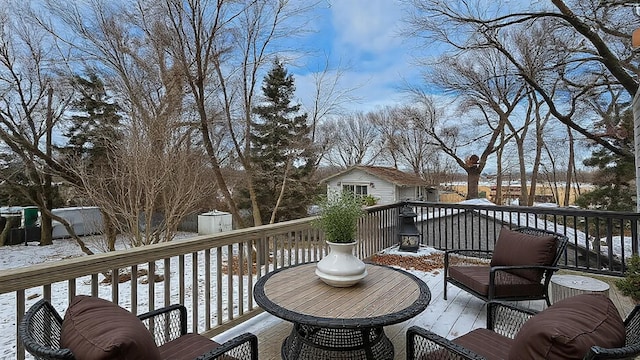 snow covered deck with an outdoor structure