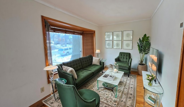 living room featuring ornamental molding, baseboards, and wood finished floors