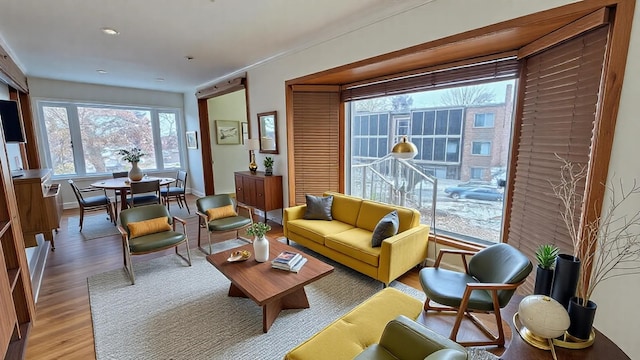 living area featuring light wood-style flooring and baseboards