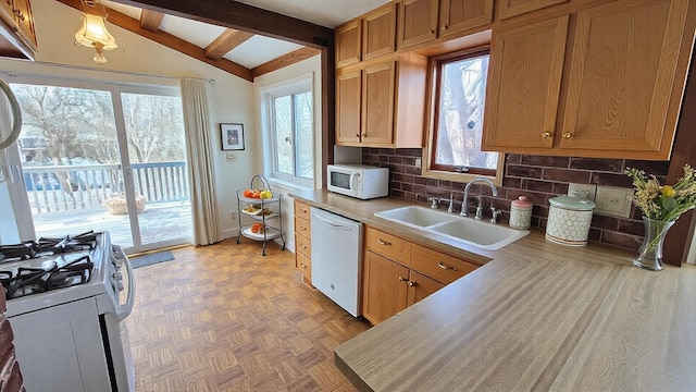 kitchen with vaulted ceiling with beams, white appliances, a sink, tasteful backsplash, and plenty of natural light