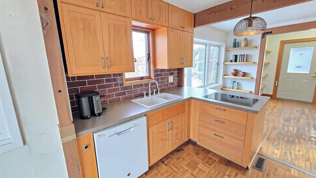 kitchen with white dishwasher, black electric cooktop, a peninsula, a sink, and visible vents