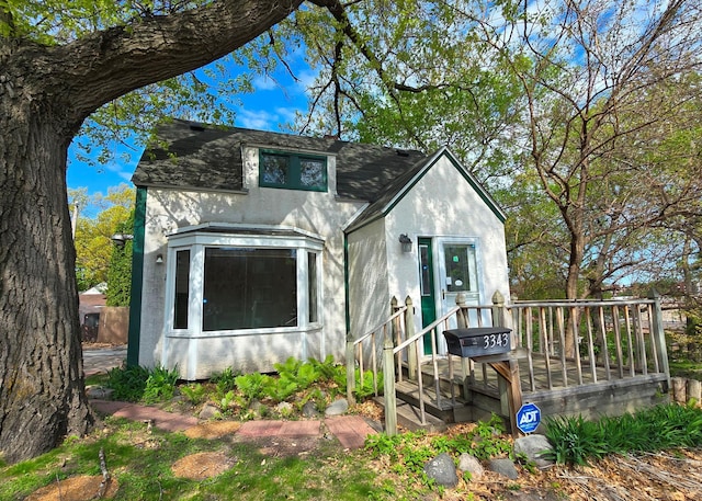 3343 Drew Ave N, Robbinsdale, MN 55422 - view of front facade featuring stucco siding, a deck, and a shingled roof