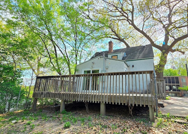 3343 Drew Ave N, Robbinsdale, MN 55422 - rear view of property featuring a chimney, a wooden deck, and stucco siding