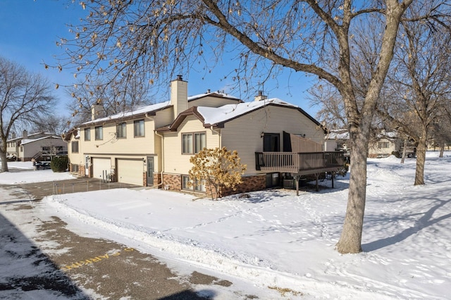 exterior space with a chimney and an attached garage