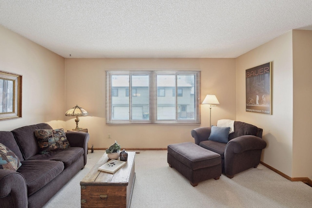 living room with baseboards, a textured ceiling, and light colored carpet